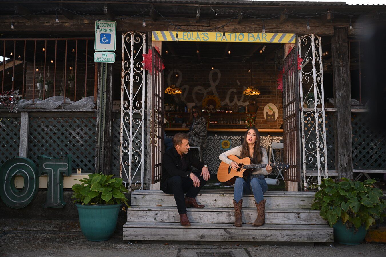 Two musicians on a café porch
